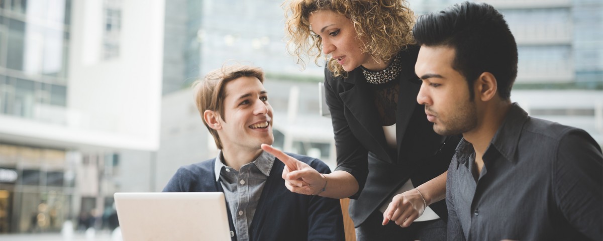A female employer teaching her employers about Internet security tips for small business.