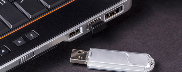 USB flash drive next to laptop