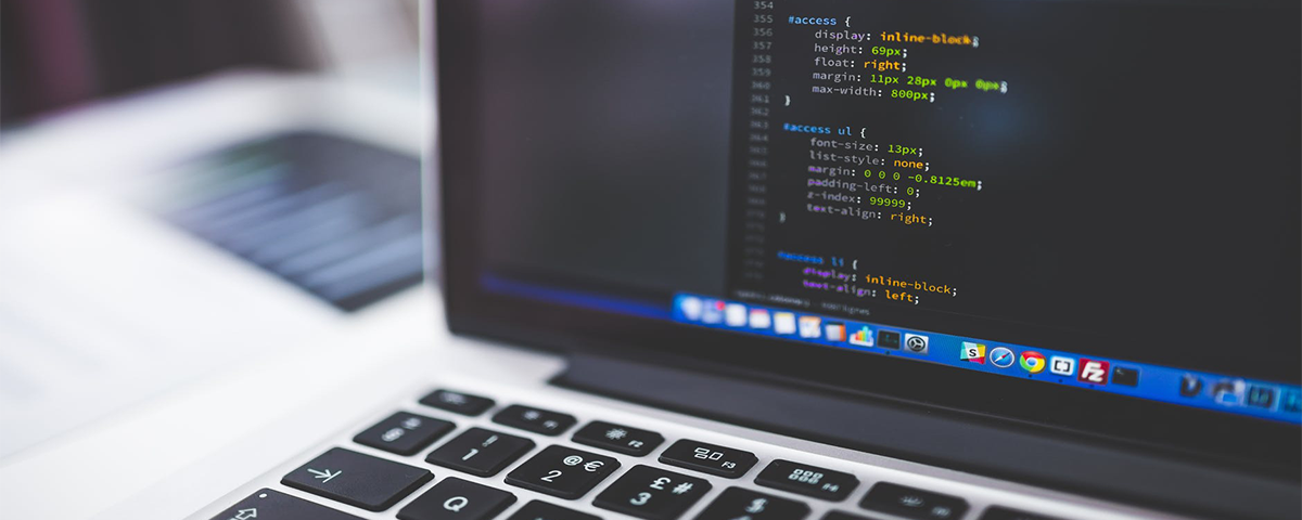 Computer with HTML website code on the screen