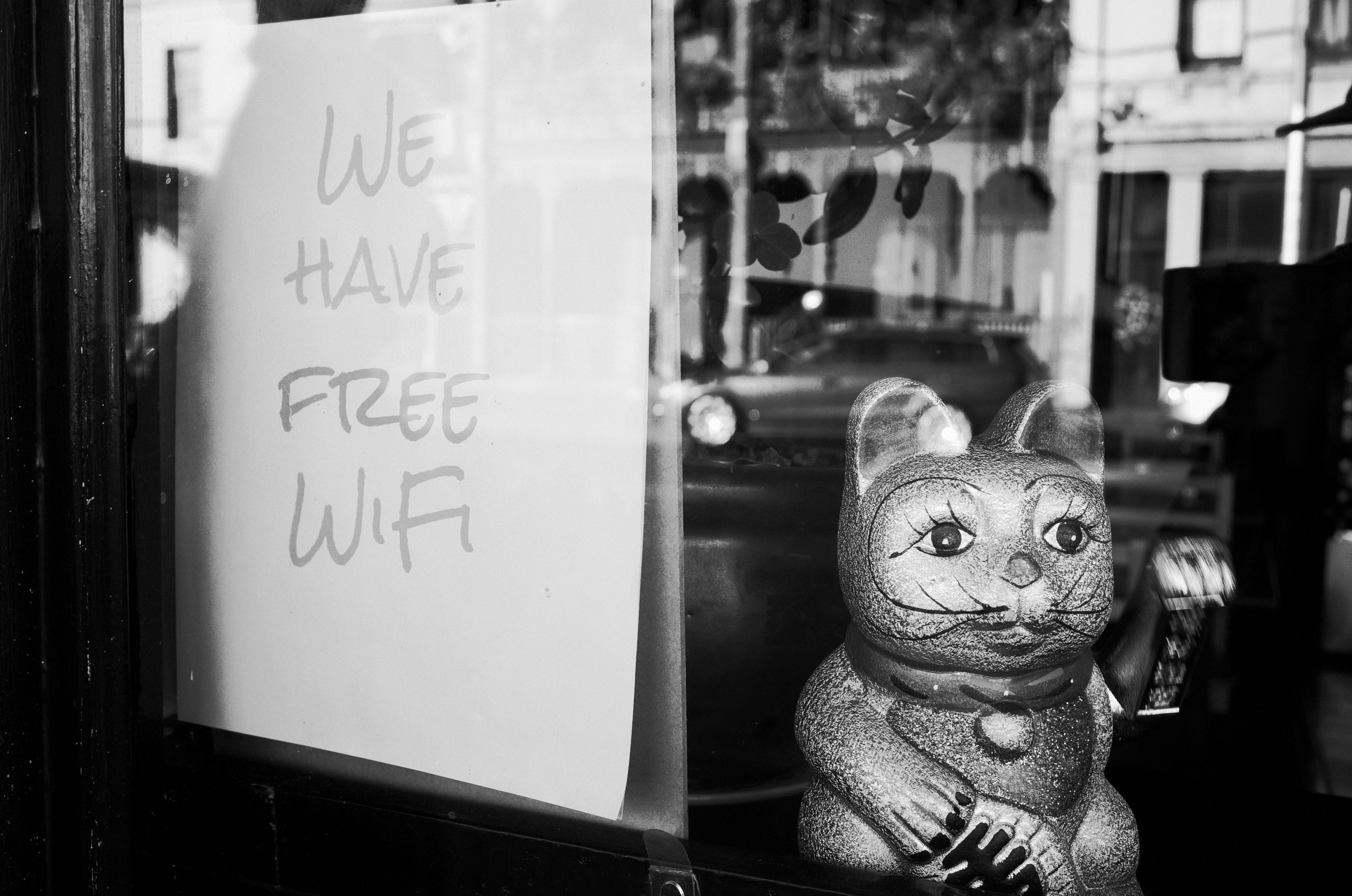 Shop window sign with "we have free WiFi" written on it