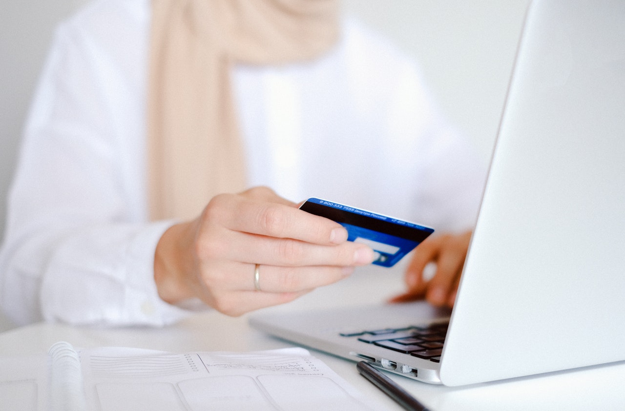 Person using credit card to shop online