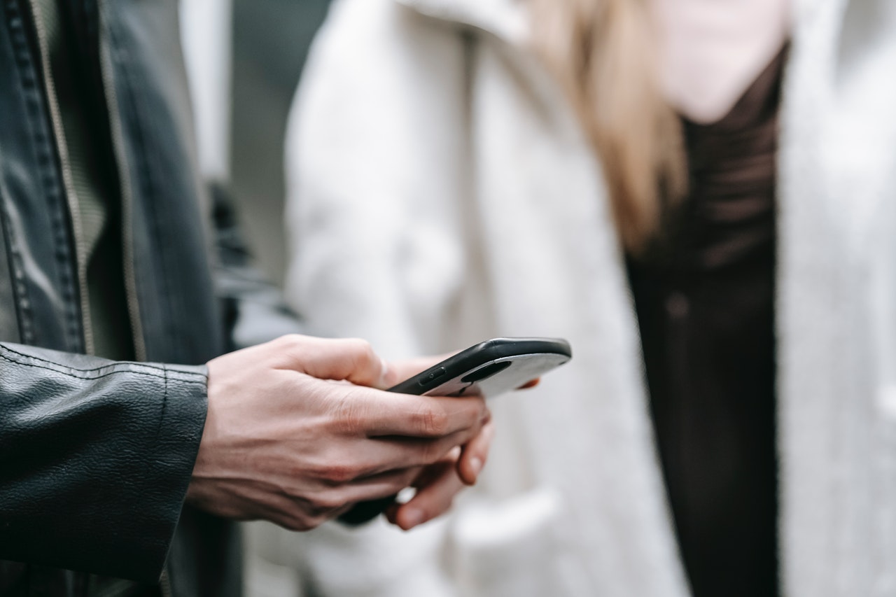 Person looking at their cell phone that is in their hand