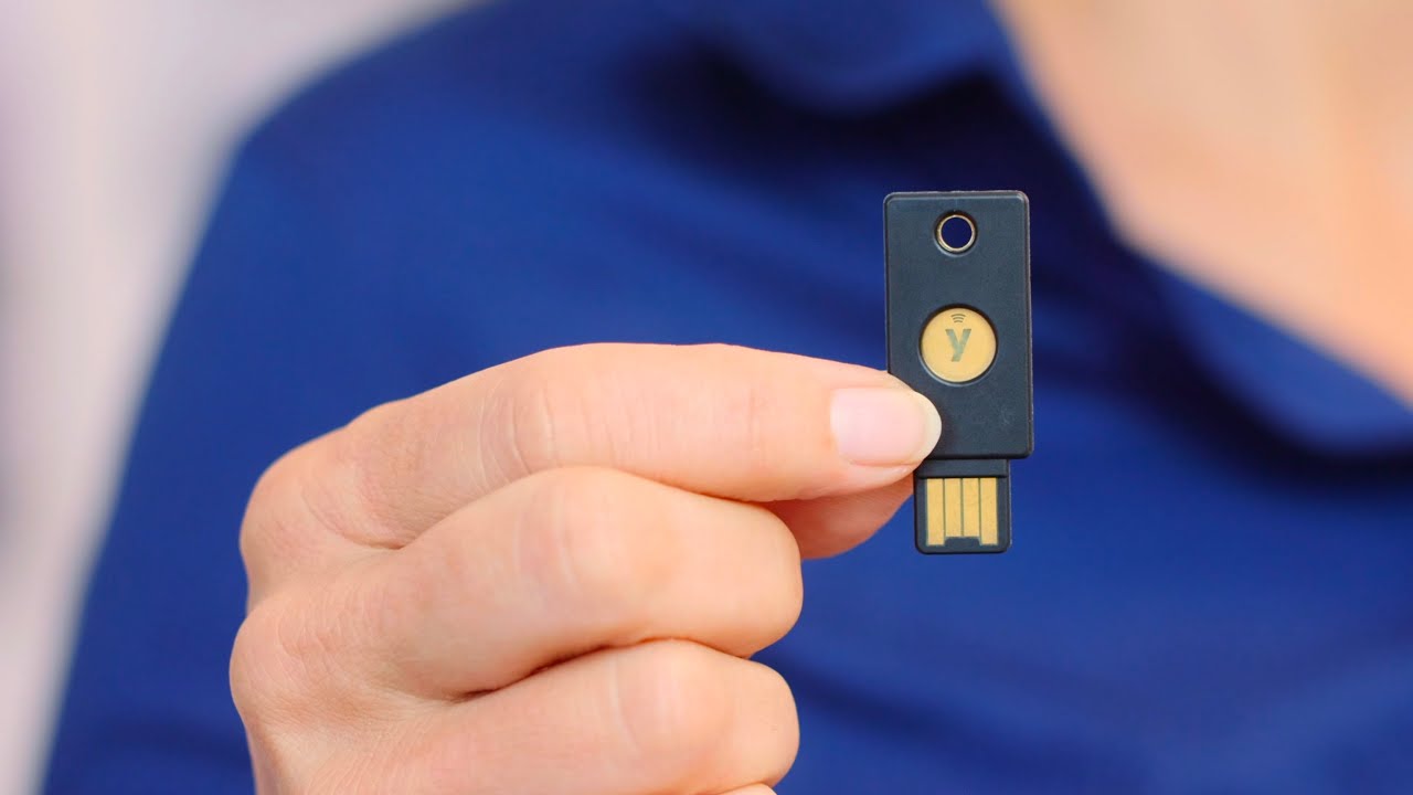 Man holding up a YubiKey