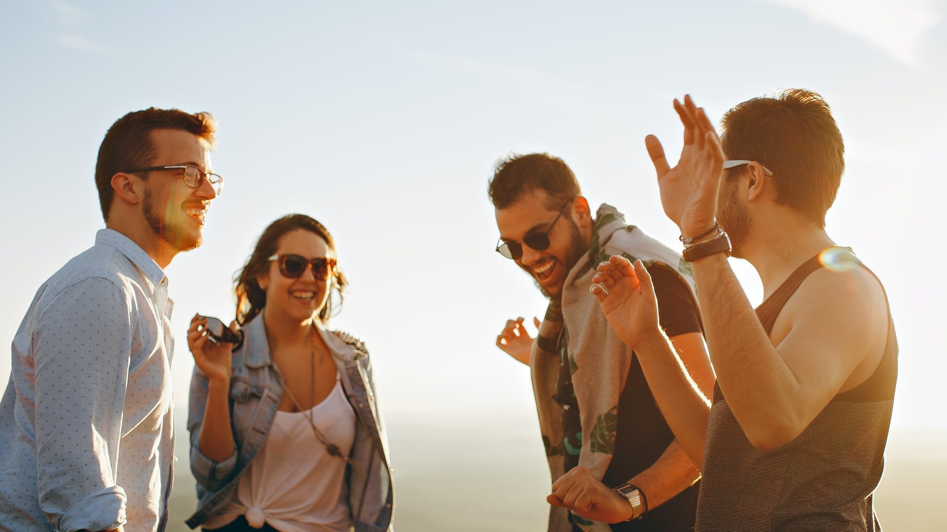 Group of young adults smiling in the sun