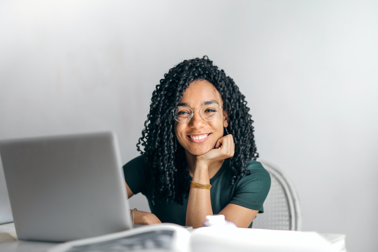 A smiling woman using a computer
