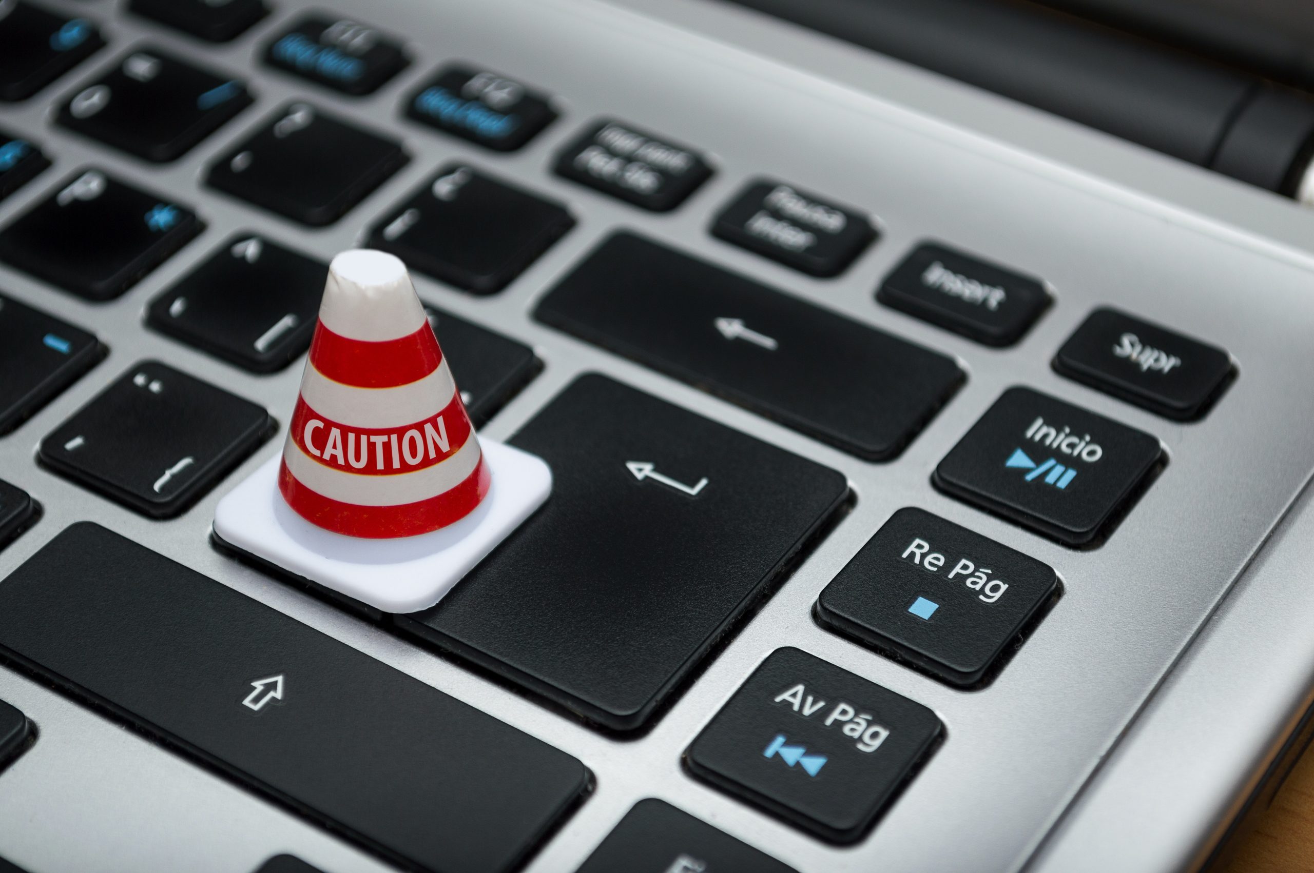 computer keyboard with a small white caution pylon on it